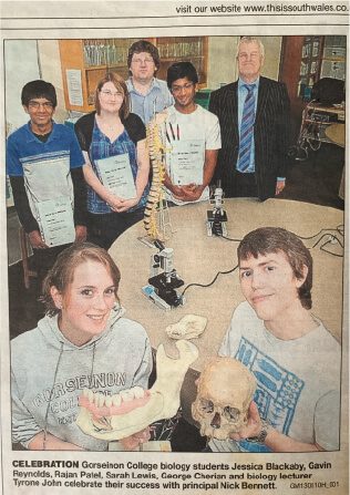 Newspaper article showing Tyrone John with Gower College Swansea Biology Olympiad medal-winning students in their second year of competition