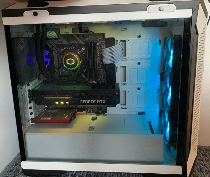 Tyrone's custom-built triple-monitor workstation used for online A-Level Biology tuition, showing Sony 4K primary display and teaching resources